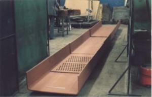 Liner manufactured with press formed corners replacing previous fabricated configuration which failed prematurely due to weld fatigue. Screen insert secured with integral countersunk bolt fixing.